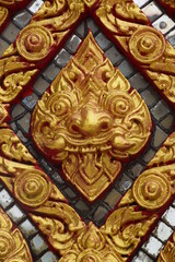 Fototapeta na wymiar Golden painted Thai temple wall