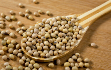 Soybeans in a wooden spoon on the table