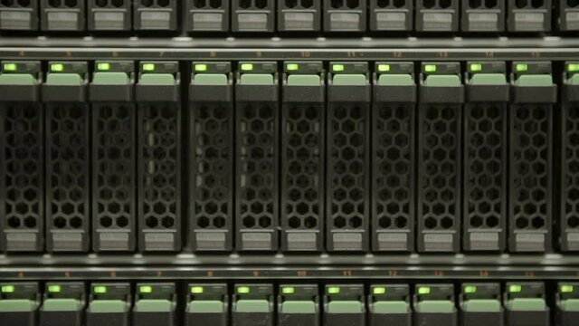 Close-up panning shot of cloud computing system with blinking lights in server room - Silicon Valley, California