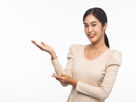 Portrait of young asian business woman pointing up isolated on white background.