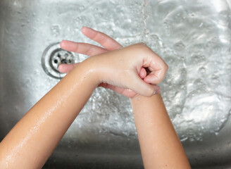 Fototapeta premium Coronavirus pandemic prevention wash hands with soap warm water and rubbing nails and fingers washing frequently or using hand sanitizer gel.