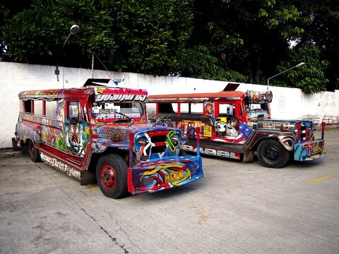 Colorful passenger jeepneys with artistic designs at a jeepney parking lot.