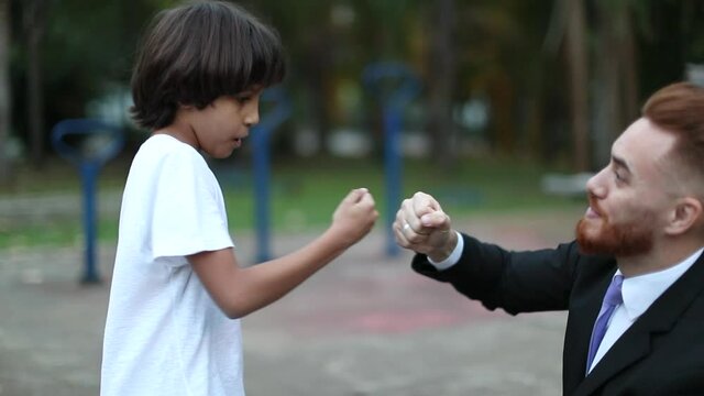 Father And Child Doing Fistbump Handshake, Racially Diverse Parent And Son