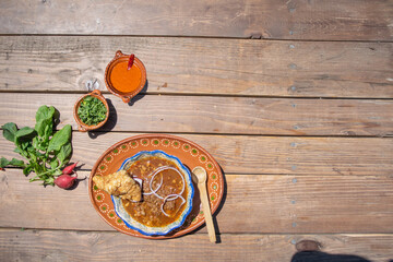 top view of mexican food with birria, hot sauce and chicharron
