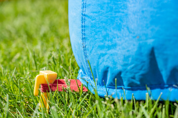 Bouncy house stake pinned into turf