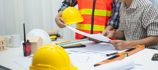 Engineers and architects work on checking the design of the engineering structure of the building.