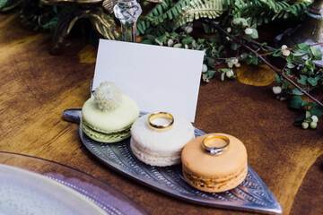 Business card presentation with macaron cookies and rings