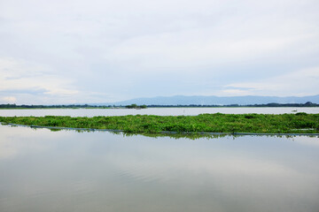 Destination twilight of sunset Reflected light on the lake surface with water hyacinth in the River