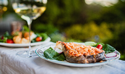 grilled salmon with salad and wine