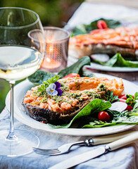 grilled salmon with salad and wine