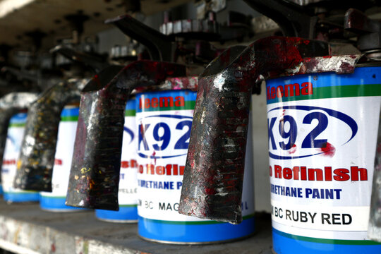 Used Paint Sprayer And Paint Cans On Display On A Shelf At A Paint Store.