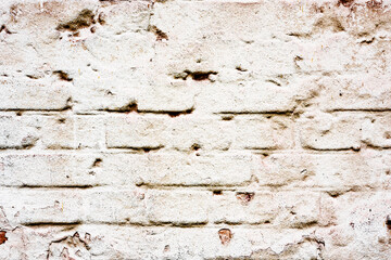 Weathered texture of stained old green and white brick wall background