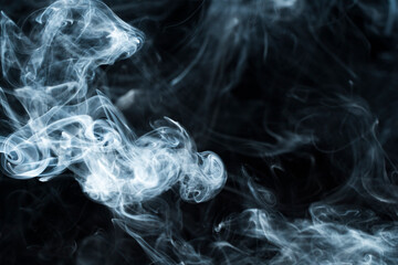 Photo of a wisp of smoke on a dark background