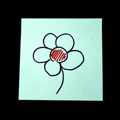 Paper sticker with the image of the flower symbol on dark background.