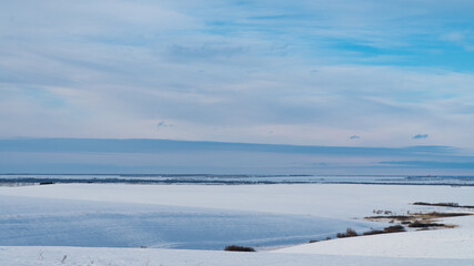 Landscape of snow covered countryside with beautiful sky