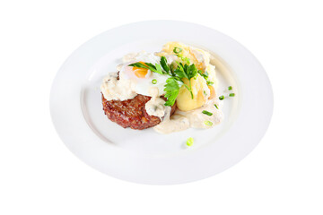 A large juicy cutlet with mashed potatoes and fried eggs on a white plate. Copy of the space.