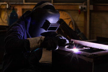 Metal workers use manual labor. Skilled welder. Factory workers making OT. Welder is welding the...