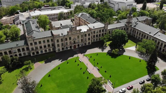 Ancient university building aerial drone around movement brick facade yard Kiev Polytechnic Institute Ukraine