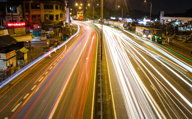 Fototapeta na wymiar Light trails of vehicles in a street at night in Colombo Sri Lanka