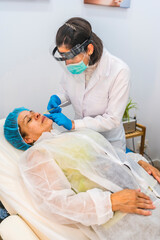 Preparing injections for platelet-rich plasma treatment for a client's face on the return to work after the coronavirus pandemic. Beauty salon center. Covid-19