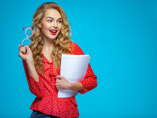 Businesswoman in a casual clothes holds papers looking away. Woman secretary in a red shirt over...