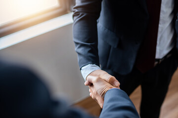 successful contract negotiate and handshake concept, two businessman shake hand with partner to celebration partnership, teamwork, business deal in room meeting after success communication, agreement