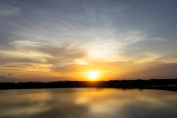 Sunset sky with water reflection on the lake.