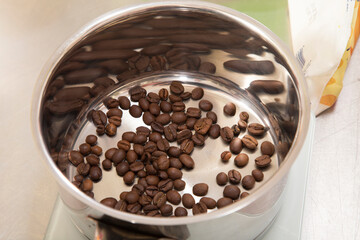 Coffee beans are at the bottom of the saucepan.