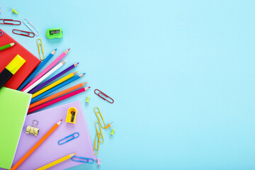 Fototapeta premium Different school supplies on blue background