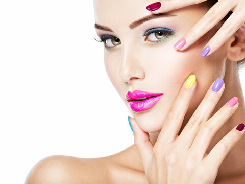 beautiful woman  with multicolor nails and fashion makeup