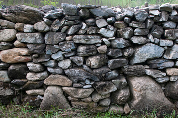 Wall of stones in China. Dry masonry.The background is a folded stone wall.