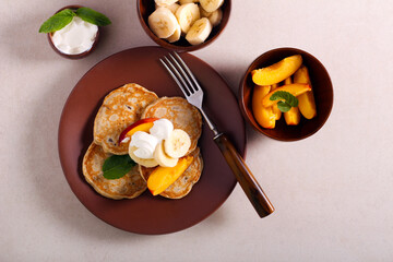 Banana and sultana pancakes with fruit topping