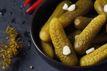 Homemade small  cucumbers, fermented, salted or marinated pickles with garlic, chili and dill