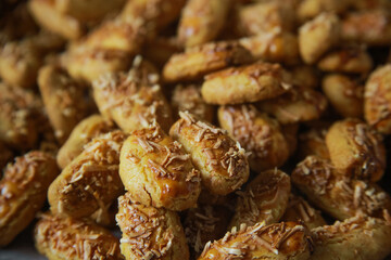 close up photo of Kaastangels,  cookies made from a mixture of flour, eggs, margarine, and grated cheese. This is Indonesian Speciality Cookies For Eid al-Fitr called kue lebaran