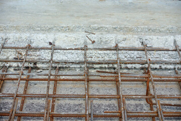 Concrete construction joint at the construction site. Wire mesh used to join cast concrete and the...
