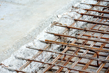 Concrete construction joint at the construction site. Wire mesh used to join cast concrete and the...