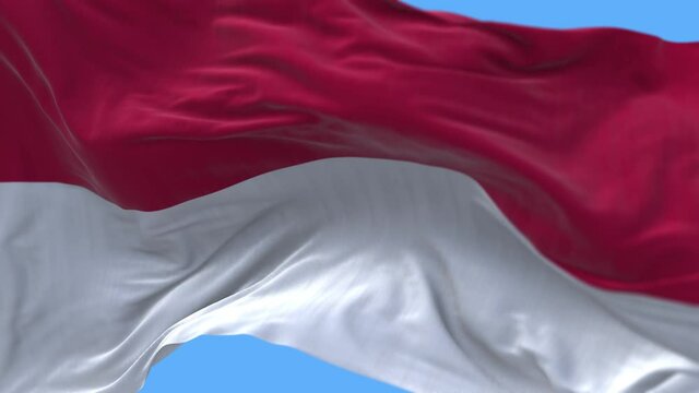 4k Monaco National flag slow seamless waving with visible wrinkles in wind blue sky background.digital rendering,animation loop.
