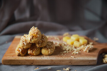 Cheese cookies on cutting board. Kaastangels are cookies made from a mixture of flour, eggs, margarine, and grated cheese. This is Indonesian Speciality Cookies For Eid al-Fitr called kue lebaran