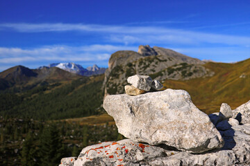 Tower of stones to make a wish stands on the top of the rock. Selective focus.