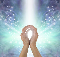 Distant Healer sending Energy out where needed - female hands with cupped fingertips touching on an...