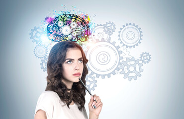 Pensive young woman with pencil brainstorming