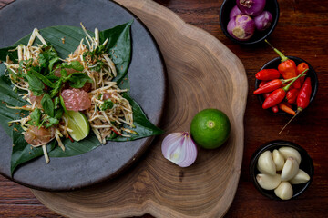 Indonesian cuisine- Balinese spicy mango salad with vegetables, sprouts, grapefruit or pomelo, mint leaves and chili.