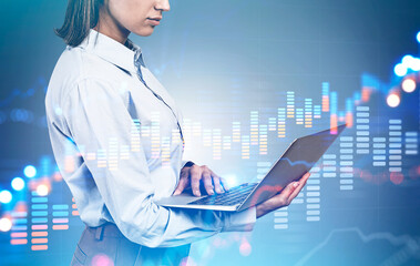 Businesswoman with laptop, growing graph