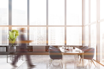 Man in panoramic dining room with blue chairs