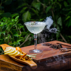 Alcohol cocktail with dry ice smoke effect. Art delicious cocktail