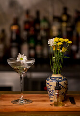 Martini alcohol cocktail garnished with flower. Art delicious cocktail in bar