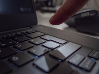 Finger hitting Enter on a laptop Keyboard