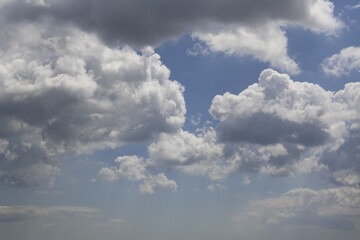 white fluffy clouds in the blue sky.