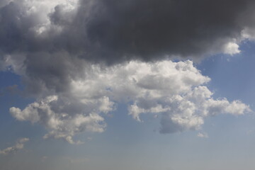 white fluffy clouds in the blue sky.