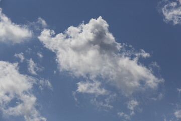 white fluffy clouds in the blue sky.
